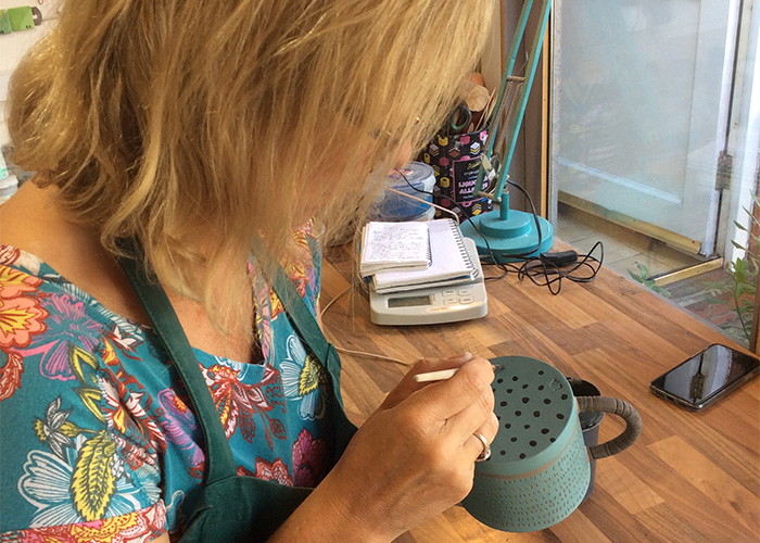 lisa painting a ceramic cup