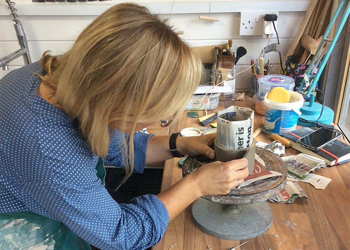 lisa in home studio building a pot with her hands