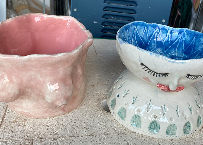 finished ceramic work of arts. one pink in the shape of breasts. 