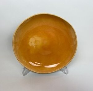 Large Earthenware clay dish, colored in a green outside with a egg yellow inside, inspired by a kiwi fruit. 