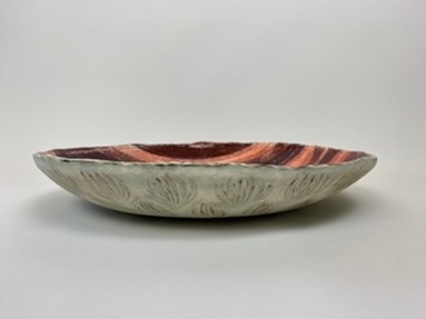 Large Earthenware clay dish, colored in a deep burgundy with contrasting pink textured stripes. 
