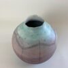 A handmade earthenware coiled pot, colored in cold purples and blues, with a grey gloss glaze on the interior, inspired by a sunrise on a cold winters morning. 