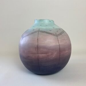 A handmade earthenware coiled pot, colored in cold purples and blues, with a grey gloss glaze on the interior, inspired by a sunrise on a cold winters morning. 