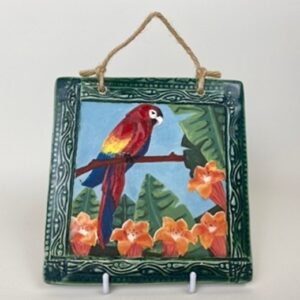 A handmade earthenware hanging wall tile. This tile design came from the parrot that carries a message of celebration. It can symbolise beauty within and around you. 